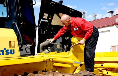 AIS employee visually inspecting equipment